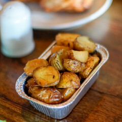 Roasted potato on aluminum foil on the table 