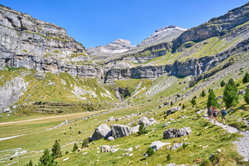 A group of women hikers in the Ordesa Valley. The Cola de Caballo waterfall is in the background, Pyrenees, Spain.