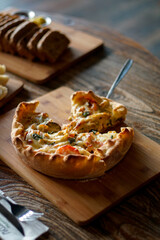 Close up of deep dish pizza pie on wooden table