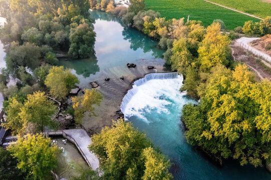 Manavgat Waterfall, Antalya. Stunning aerial view of Manavgat Waterfall with its vibrant turquoise waters and lush green vegetation. A breathtaking natural wonder from above.