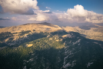 Fototapeta premium Sunny mountain slopes, sun shadows reflected on distant mountains. Exquisite natural scenery.