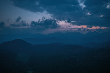 A magnificent combination of cloudy sky and mountain forest scenery. Cloud and mountain slopes.