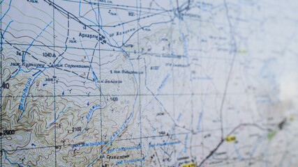 Topographic map with geographical coordinates, roads, terrain contours and marked locations, abstract background