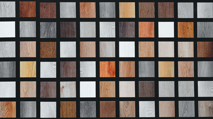 Multicolored wood samples as a textured abstract background. Samples are arranged in a grid. Samples have different colors and sizes