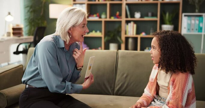 Child, woman and speech therapy for counseling evaluation with cards or psychology treatment, diagnosis or questions. Girl, kid and mature person on couch for language learning or mouth, lisp or help