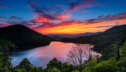 Fototapeta premium Colorful sunset over Julian Price Lake along the Blue Ridge Parkway