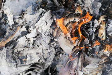 Burning documents. Paper fire. Confidential files destroyed. Flames and ashes. Secure data disposal. Privacy protection concept. Intense heat. Risk and danger. Smoke and destruction.