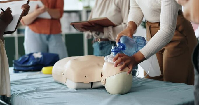 Ventilator, cpr and people with dummy for learning, tutorial or lesson for paramedic course. Healthcare, safety and woman with group and respiratory mask for demonstration, first aid or medical class