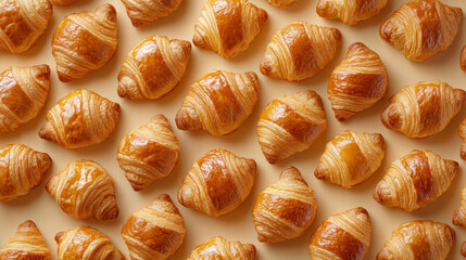 Freshly baked golden croissants on white wood, top view. symmetry patterns. croissant on cream background.