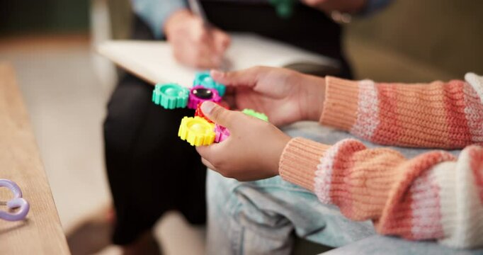 Child, psychologist and toy playing for therapy counseling or adhd stimming or sensory, stimulation or calm. Kid, hands and helping in office for diagnosis service or youth advice, autism or anxiety