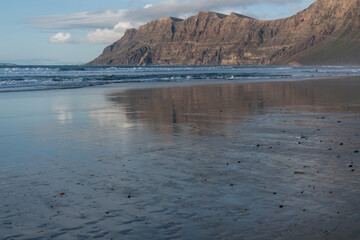 Caleta de famara sandy beach at sunset, Canary island	