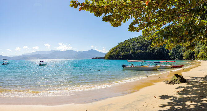 Taxi boat anchored at Abra&atilde;ozinho Beach with taxi boat and blue waters in Abra&atilde;o, on tropical Ilha Grande, Angra dos Reis, south of Rio de Janeiro Brazil