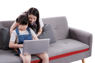 Smiling Asian mother teaching daughter for online learning with laptop together on sofa at home. Child educational for homeschooling concept