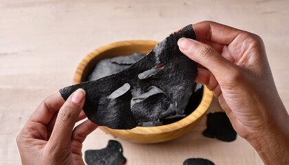 hand holding a black mask