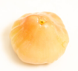 A small, round, yellow fruit with a stem on top