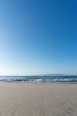 Seascape View Clear Blue Sky with Sandy Beach and Gentle Waves