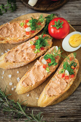 Fresh homemade chicken liver pate on baguette with fresh parsley and spices