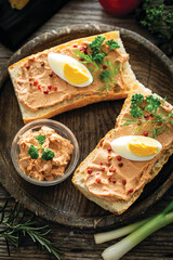 Fresh homemade chicken liver pate on baguette with fresh parsley and spices