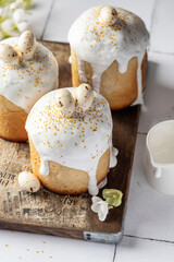 Delicious Easter Kulich cakes, festively decorated with glaze and colorful toppings on white background