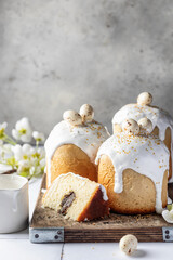 Delicious Easter Kulich cakes with poppy seed filling, festively decorated with glaze and colorful toppings with spring flowers
