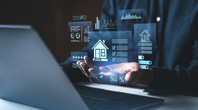 Digital real estate data analysis with futuristic holograms above laptop and hands on creative dark background concept of property investment technology.