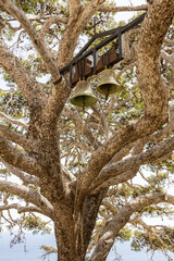 Tree with two bells at church at Monastery of St. John the Theologian, known as Monastery of Preveli (rebuilt in 1878). Crete, Greece.