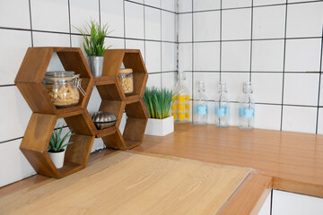 A minimalist shelf sits neatly on the kitchen countertop, holding everyday essential