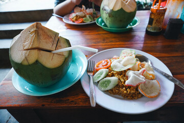 Enjoying Indonesian Fried Rice and Fresh Coconut Water at Outdoor Cafe