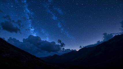 Fototapeta premium Serene Night Sky Over Majestic Mountains With Soft Cloud Cover