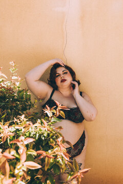 Plus size old Hollywood lingerie model outdoors