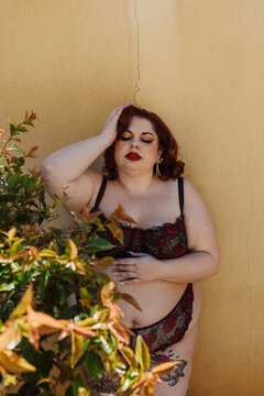 Plus size old Hollywood lingerie model outdoors