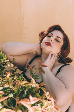 Plus size old Hollywood lingerie model outdoors