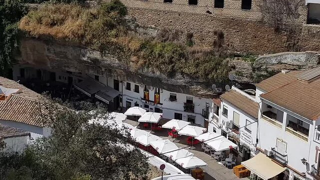 Slow panoramic shot of Setenil de las Bodegas, the famous rock town in Andalusia, Spain