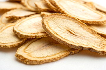Detailed American Ginseng Herbal Slices on White Surface