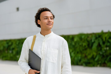 Young Professional with Laptop in Urban Setting