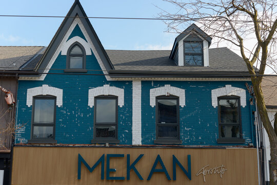 exterior building facade and ghost sign of Mekan  located at 817 Queen St W in Toronto, Canada