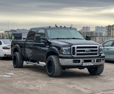 Ford F-350 4x4 black color parked on street. Exterior Ford F-350 SRW Crew Cab XL pickup off-road us vehicle. USA SUV Ford F-350 at the parking. American SUV. 