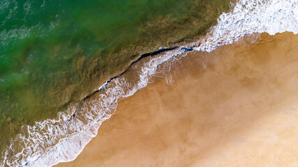 Aerial close up of water flowing into the water