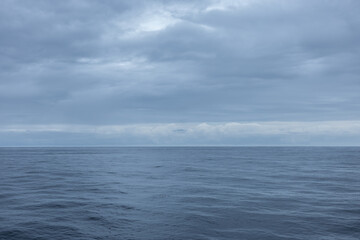 Overcast gloomy calm day on a cruise ship and the view of the endless ocean horizon