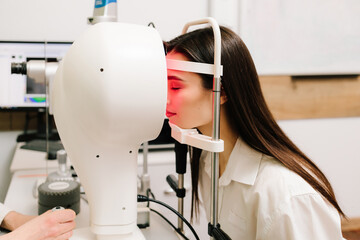 Corneal topography eye vision test for visual description of the shape and power of the cornea. Red...