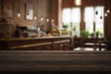 Empty wooden table and blurred background of abstract in front of restaurant or coffee shop for display of product or for montage.