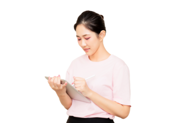 A young woman in a pink shirt is holding a tablet and writing on it with a stylus.