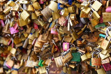 Fototapeta premium A bunch of gold and silver locks with colorful writing on them