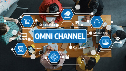 A vibrant team collaborates around a table, discussing omni channel strategies essential for...