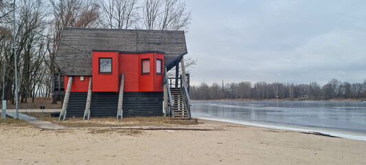 Lifeguard hut at the river cost. Patrol station at the public swimming spot. Overcast during winter in Europe.
