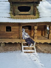 Tiny dwarf village hidden in the forest. Snow covered elf houses. Whimsical travel place. Kid exploring gnome house.