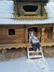 Tiny dwarf village hidden in the forest. Snow covered elf houses. Whimsical travel place. Kid exploring gnome house.