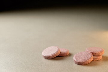 Natural supplements resting on a smooth surface illuminated by soft light