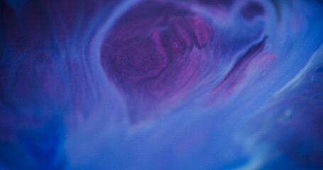 Blur shimmering. Defocused paint pouring. Blinking gleaming paint purple blue color liquid turning on modern bokeh light background.