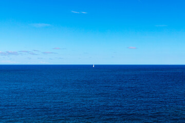 Obraz premium Beautiful seascape of the Adriatic Sea with a sailboat barely visible in the distance